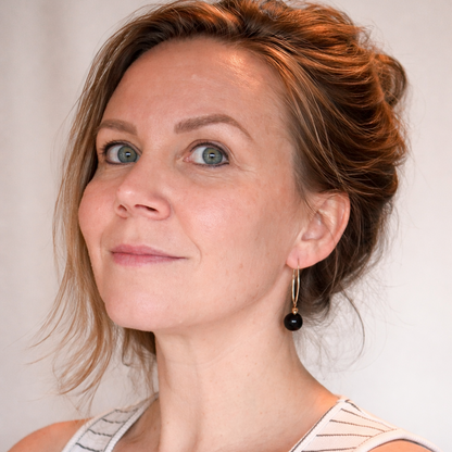 Dangling silver earring with amber bead at the end 