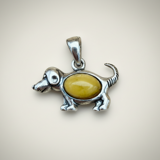 Dog-shaped pendant with a milky yellow amber
